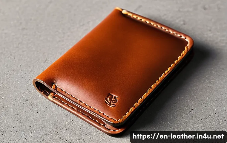 가죽공예 디자인 아이디어 - **Prompt:** A close-up, high-definition photograph of a minimalist leather cardholder. The cardholde...